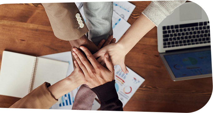 Collaborative hands joined over SEO planning documents